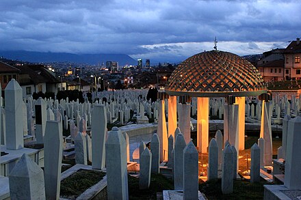 Alija Izetbegović tomb in the Kovači Memorial Cemetery at dusk.