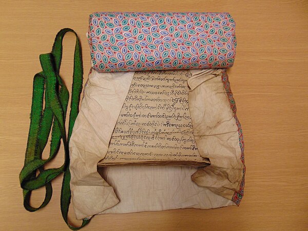 Shan paper manuscript bound with a patterned cotton cloth cover and a felt binding ribbon, Shan State, first half of the 20th century. British Library