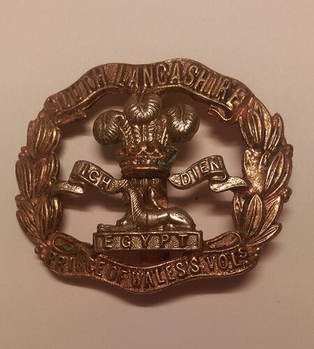 Cap badge of the South Lancashire Regiment.