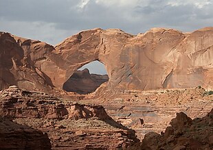 Stevens Arch, near the mouth of Coyote Gulch in the Canyons of the Escalante, is formed from a layer of Navajo Sandstone. The opening is 220 feet (67 m) wide and 160 feet (49 m) high. StevensArchUT.jpg