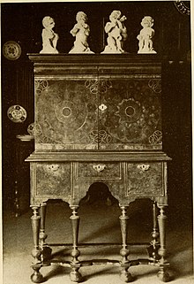 A William and Mary style cabinet with oyster veneering and parquetry inlays The practical book of period furniture, treating of furniture of the English, American colonial and post-colonial and principal French periods (1914) (14778886135).jpg