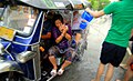 People in a tuk-tuk getting soaked during Songkran, Chiang Mai