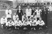 Formal team photo on the pitch, with a small American flag