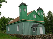 Historic wooden Kruszyniany Mosque, used by Polish Tatar community, and targeted by an Islamophobic attack in 2014 Wikipedia-mosquee-kruszyniany.jpg