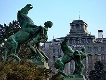 Sculpture of two horses playing with humans