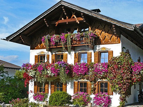 Alpine country house with balcony flowers in Ehrwald, Austria