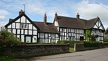 Black-and-white cottages in the centre of Marbury village, a conservation area