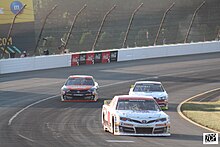 Haugeberg (No. 11) racing Ed Pompa (No. 44) and Jon Garrett (No. 10) in the ARCA race at Pocono in 2022 Bryce haugeberg (52240842977).jpg