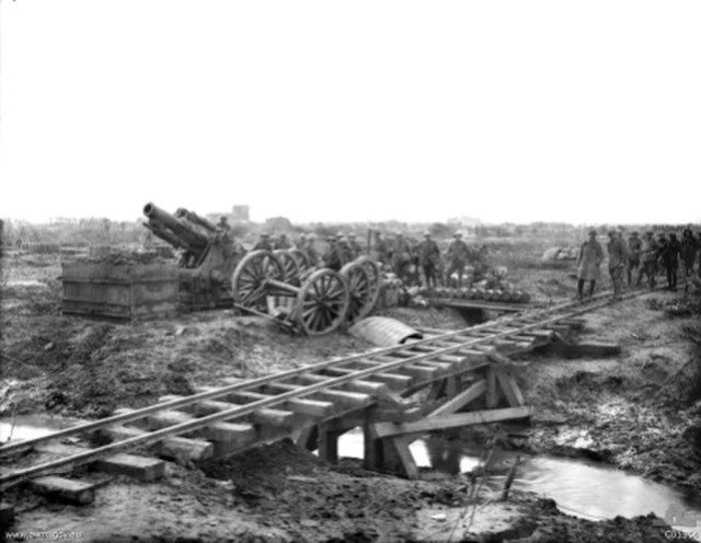 A BL 9.2-inch howitzer with shells lined up on the ground recently delivered from the trench railway in the foreground during World War I.