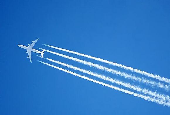 An Airbus A340's engines leaving a water condensation trail (contrail) – miniature clouds formed by the engine exhaust