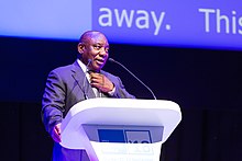 Cyril Ramaphosa speaking at the ITU Telecom World in 2018 in Geneva, Switzerland. Cyril Ramaphosa (30723014148).jpg