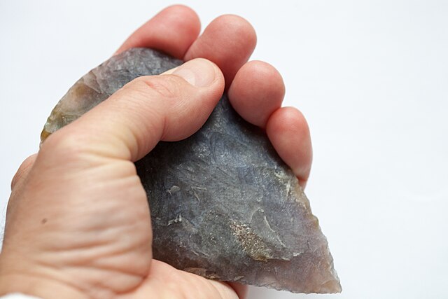 A person holding a hand axe