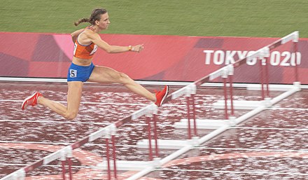Bol running during heavy rain in the semi-final of the 2021 Tokyo Olympic Games