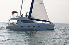 With no boom that could sweep them into the sea, sailors on this mast-aft rig are able to utilize the roof of the pilot house. HK 40 Catamaran.jpg