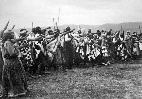 A group of men and women perform a haka for Governor Lord Ranfurly at Ruatoki, Bay of Plenty, 1904