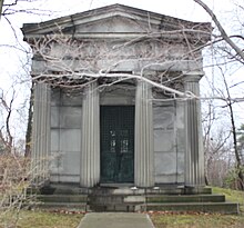 A mock Greco-Roman style mausoleum, about the size of a small house
