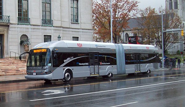 A HealthLine BRT vehicle drives through University Circle passing the Allen Memorial Medical Library.