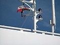 Hoisting the courtesy Welsh Dragon on the Jonathan Swift as she enters Holyhead