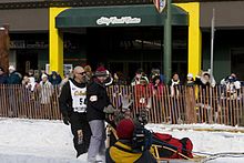 Ellering on Fourth Avenue in Anchorage during the ceremonial start of the 2006 Iditarod. Iditarod- MG 0103 (1392680415).jpg