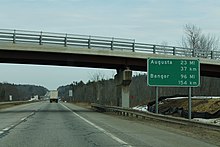 Mileage sign displaying both miles and kilometers on Interstate 95 in Maine Int95nRoadME-Augusta23miBangor96mi (35256201132).jpg