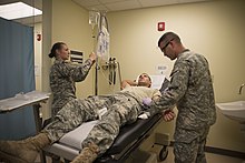 U.S. Army Sgt. Charles Wilkins with the 313th Medical Company (Ground Ambulance) of the Nebraska Army National Guard demonstrating his technique to administer an IV JRTC 14-08 140616-Z-LK849-594.jpg
