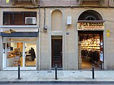 *1858-L'Empresari Antoni Saladrigas obra una fàbrica d'Indianes -estampas- i any més tart construeig unes vivendes al carrer St. Pere Taulat nros. 79 al 85 per als seus treballadors. Pels vols de 1925 tanca la fàbrica i nous veins i comerciants lloguen aquelles vivendes.*1896-St. Pere Taulat 67bis. Rodrigo /Antoni), graneria.*1908-St. Pere Taulat 67bis. Iscla (Francesc), vins i olis. *Mas (Josep), adroguer. *Pladellorens (Pere), adroguer.*1912-Marià aguiló 67bis. Luís (Francesc), adrogueria. *Iscla (Francesc), bodega.*1920-Marià aguiló 67bis. Gorges (Pau), vins. *Pujadas (Francesc), ferreria.*1922-Marià Aguiló 67bis. Pujadas (Francesc), electricitat.*1929-Marià Aguiló 67bis. Estrada (Lluïsa), reparació de màquines de cosir.*1934-Marià Aguiló 67bis. Estrada (Lluïsa), reparació de màquines de cosir. *Prieto (J), rellotgeria.*1942-Marià Aguiló 67bis. Borrell (Manuel), lampista. *Sintes (Xavier), rellotgeria.*1952-Marià Aguiló 67bis. L.E.F.E., material elèctric. *Sintas (Gabriel), rellotgeria.*1961-Marià Aguiló 79bis. L.E.F.E., fàbrica de làmpades.*2009-Marià Aguiló 79. CAIRE 2000, Catalana d'Instal·lacions i Reformes. *La Bodega, vins i pollastres a l'ast.