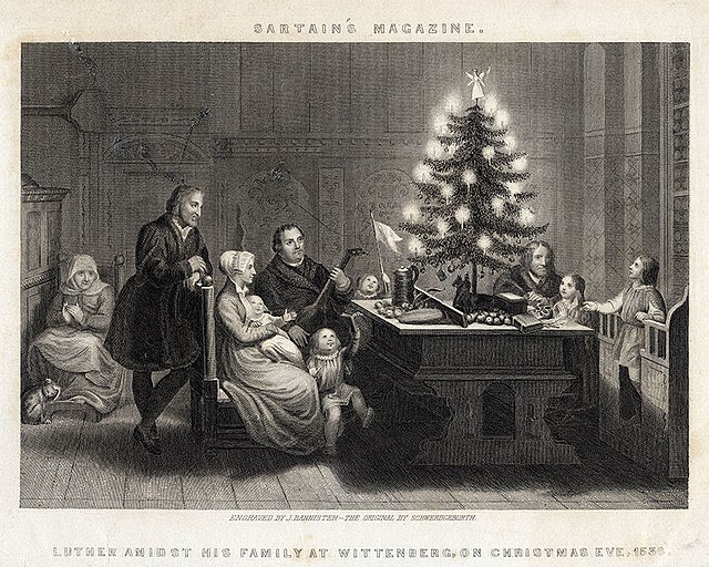 Martin Luther is depicted with his family and friends in front of a Christmas tree on Christmas Eve