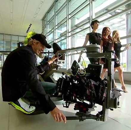 Bay filming Transformers: Age of Extinction; actresses Abigail Klein, Melanie Specht and Victoria Summer are walking in a corridor.