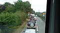 English: Part of a large traffic queue in Staplers Road, Staplers, Newport, Isle of Wight. Being the summer holidays, lots of tourists were holidaying on the island. Whenever the weather is a bit nasty, everyone decides to go to Newport for the day, which results in the whole place becoming extremely congested, sometimes nearly gridlocked. This day was one such occasion (it poured down soon afterwards). On this occasion, traffic had queued back past the last houses on Staplers Road. When I hit the congestion, the end of the queue was about half way between the junctions with Mews Lane and Blacklands Road. I was on the number 9 bus (the outside of it is seen in File:Southern Vectis 194 HW52 EPP and Newport Staplers Road traffic queue.JPG), but from past experience decided to get off and walk, as did the two people walking down the pavement in the photo, and walk the rest of the mile and a quarter journey into Newport. I walked past the traffic queue and easily beat the bus.