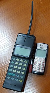 The Mobira Cityman 150, Nokia's NMT-900 mobile phone from 1989 (left), compared to the Nokia 1100, a GSM phone from 2003. Nokia 150 and nokia 1100.jpg