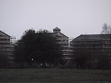 St Barnabas Church campanile obscured by new Oxford University Castle Mill graduate accommodation buildings, at the southern end of Port Meadow Obscured view of St Barnabas campanile from Port Meadow, Oxford.JPG