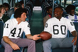 Sistrunk (60) and teammate Phil Villapiano (41) for local public transportation operator AC Transit's Project Linebacker anti-graffiti campaign, c. 1976.