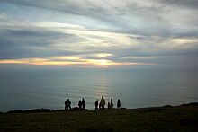 A group of people gathered to watch the sunset at Point Reyes National Seashore. People watching sunset at Point Reyes National Seashore.jpg