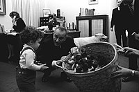 President Lyndon B. Johnson with a basket of dogs.