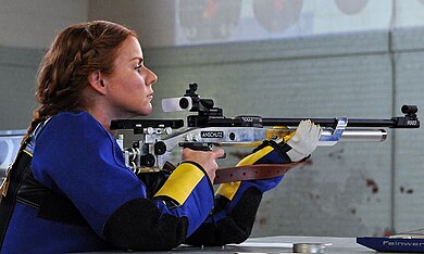 A sportwoman shooter while training running target shooting. Running target shooting.jpg