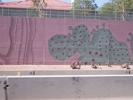 Stylized cacti decorate a sound/retaining wall in Scottsdale, Arizona