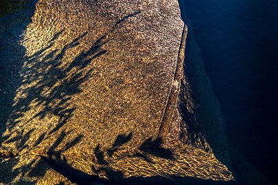 Shadows on submerged granite in Norrkila quarry