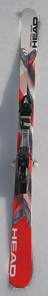 A shaped alpine ski with relatively little sidecut and classic camber: the tip and tail touch the snow while the midsection is in the air.