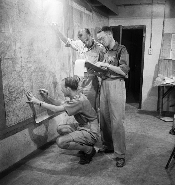 File:Staff officers plotting troop positions during the invasion of Sicily on a wall map in the underground operations room at Malta, 9 July 1943. NA4094.jpg