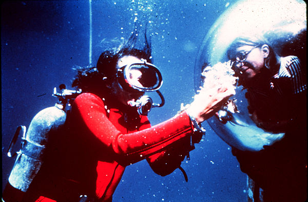 Earle displays samples to an aquanaut inside the Tektite habitat, 1970