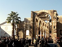 Ruins of a stone building with columns and without roof.