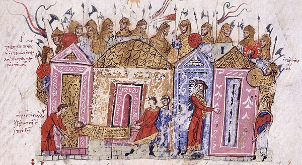Varangian Guardsmen, with prominently displayed Danish axes, arranged around a Byzantine palace. Note the sub-conical helmets of both composite and single-piece skull construction, with attached neck defences and the use of both round and kite-shaped shields