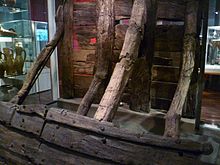 Part of a 13th-century timber wall from the Thames riverbank at Billingsgate, excavated in 1982 and displayed in the medieval galleries at the Museum's Barbican site. Timber revetment, c.1220 A.D..JPG