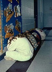 Students participate in a tornado drill, lining up along an interior wall and covering their heads. Tornado drills are an important element in tornado preparedness. Similar to other evidence based safety drills, they teach effective countermeasures and therefore increase survival rates if/when a tornado hits. Tornado drill.jpg