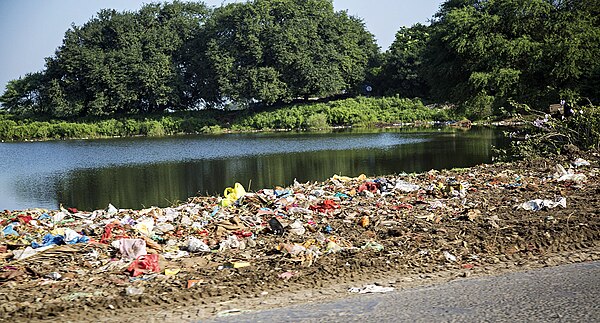 Trash dump by the river bed (13092110675).jpg