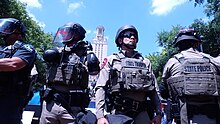 Riot police on the main lawn. The UT Tower can be seen in the background. UT Austin April 29 2024 Protest UT Tower Image.jpg