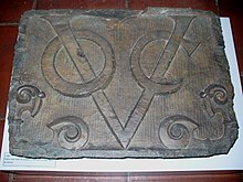 Stone with V O C logo