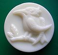 White glass self-shanked pictorial woodpecker button