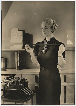 Woman holding typewriter ribbon at Royal Typewriter (7009492745)