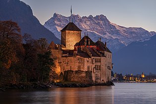 Chillon Castle at nightfall with the Dents du Midi in the background